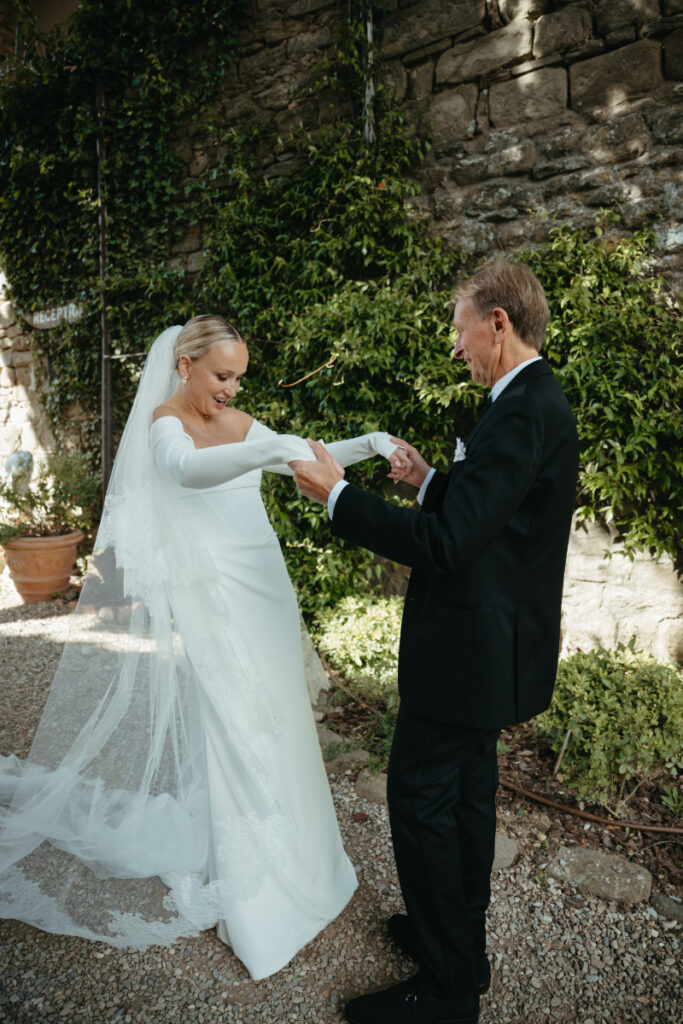 A bride shares an emotional first look moment with her father before wedding.
