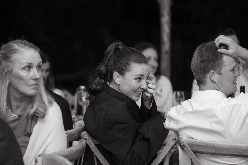 A guest smiles through happy tears during a heartfelt moment at the wedding reception, capturing the emotion that comes when you choose the perfect wedding photographer.