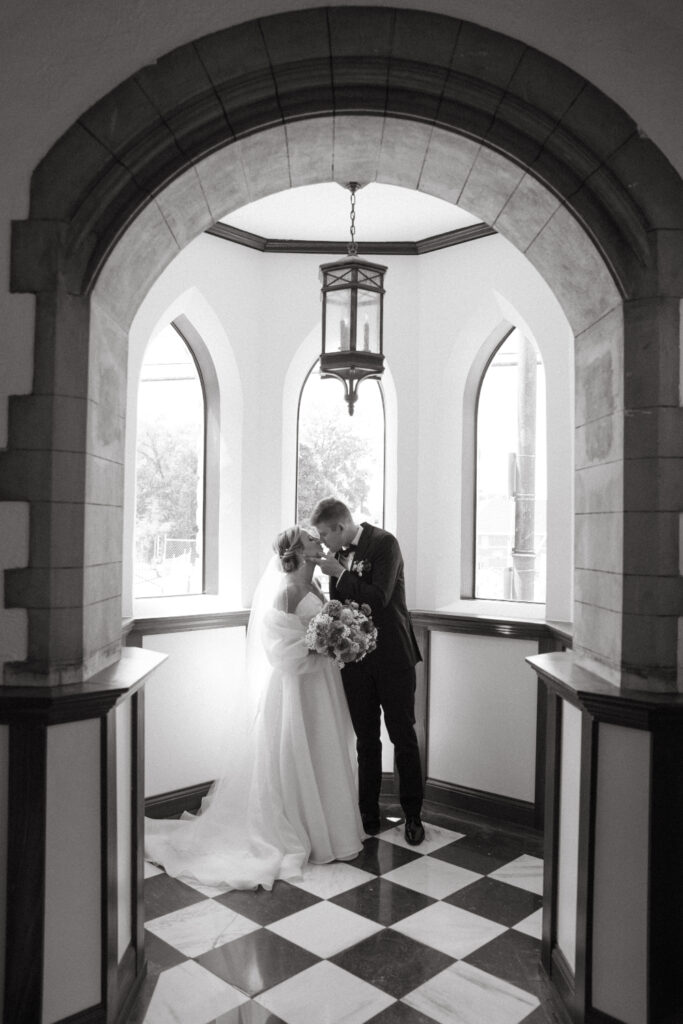 black and white photo of a bride and groom sharing a kiss at St Nicholas Church in Cincinnati 