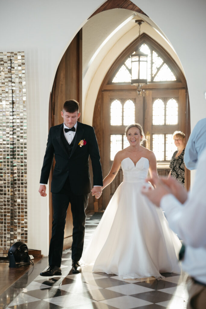 bride and groom enter the palomar cincinnati wedding reception