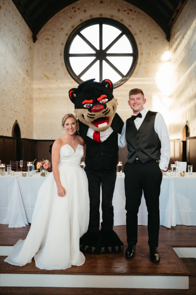 UC Bearcat mascot with bride and groom during their wedding reception at the palomar cincinnati