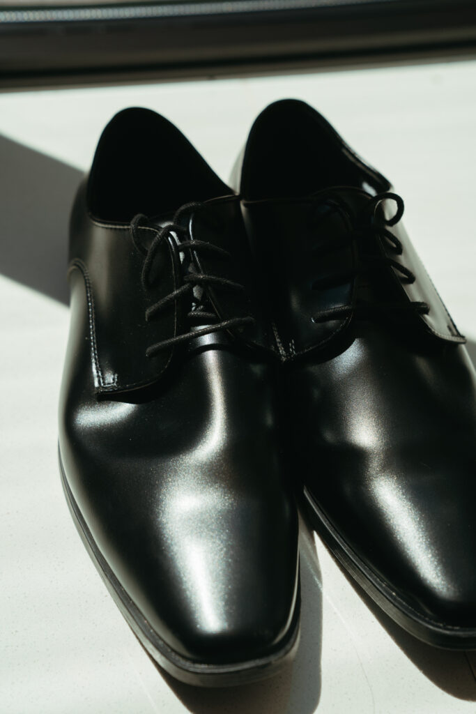 Black dress shoes in natural light.