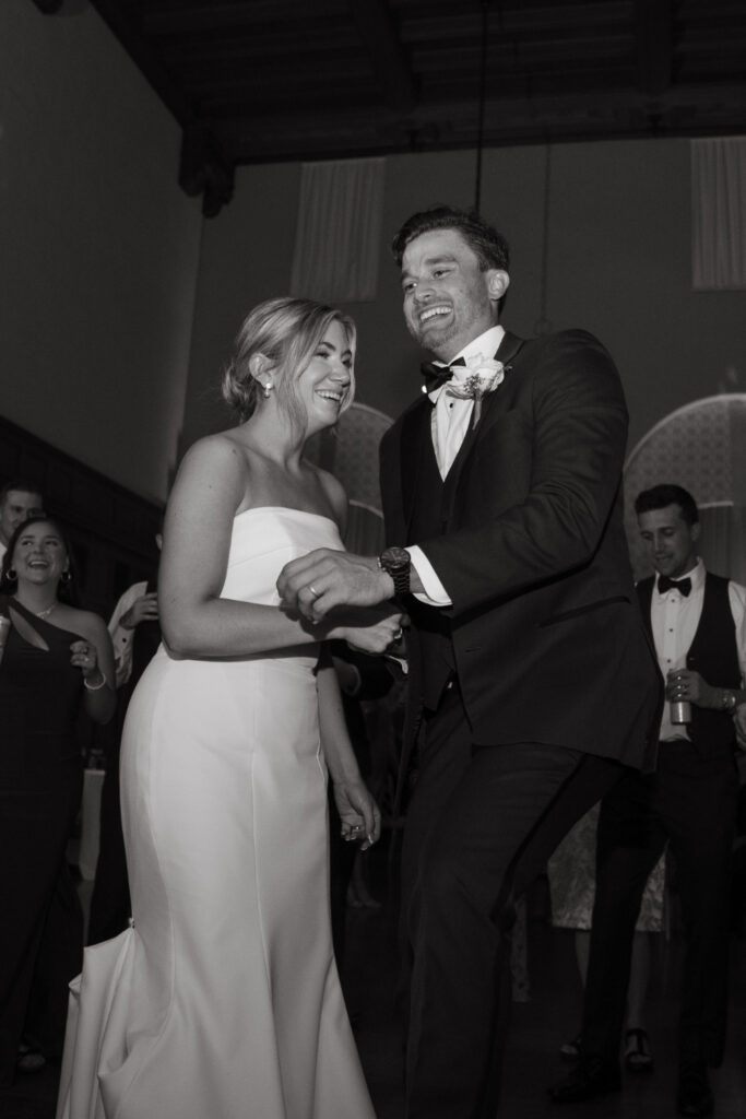 bride and groom dance at cincinnati club wedding reception with guests