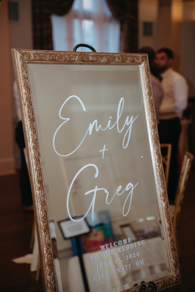 Mirror sign welcomes guests to Emily and Greg’s wedding.
