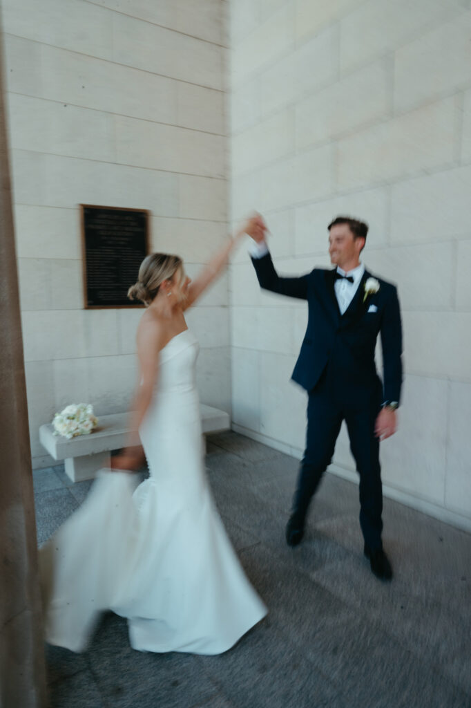 Bride and groom twirling in blurred motion.
