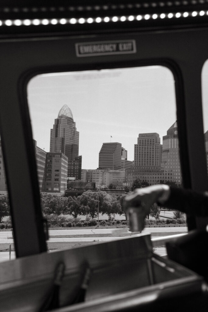 Cincinnati skyline seen through a party bus window.
