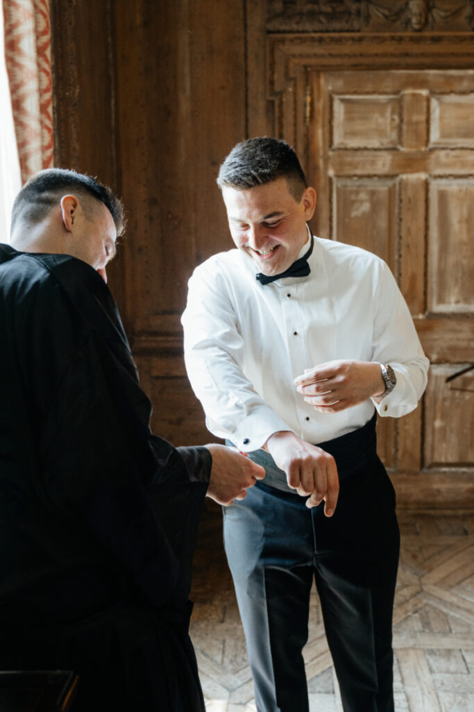 candid groom getting ready