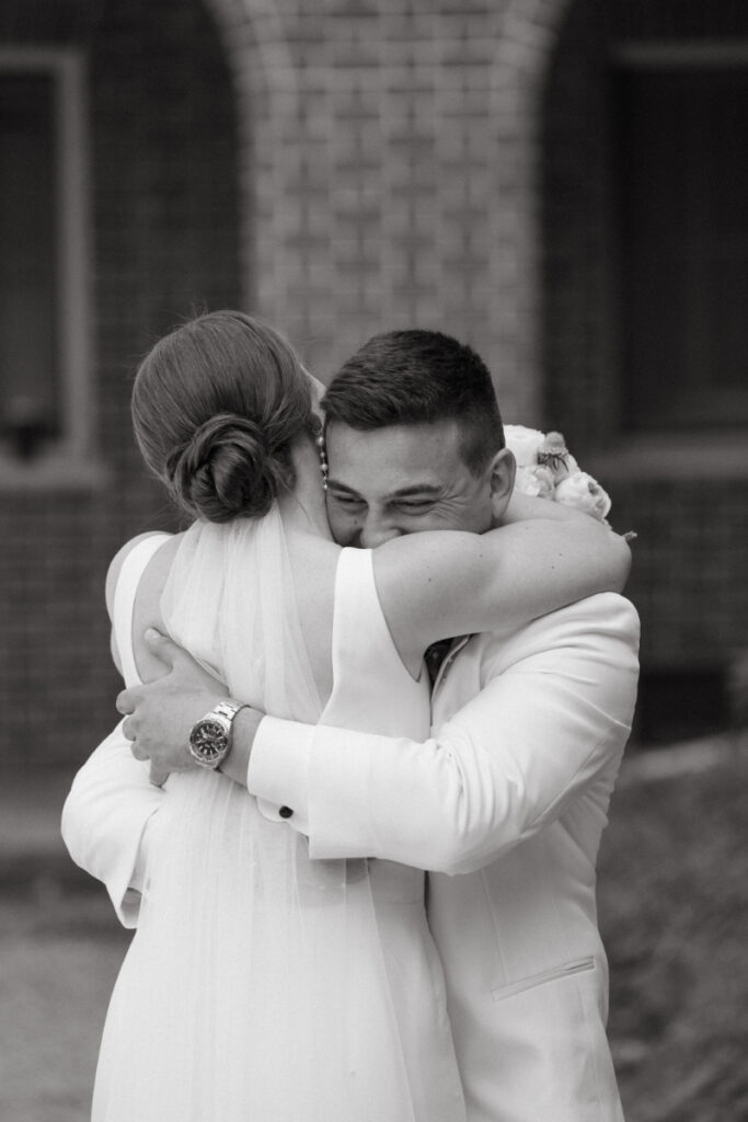 groom hugging bride in candid wedding photos