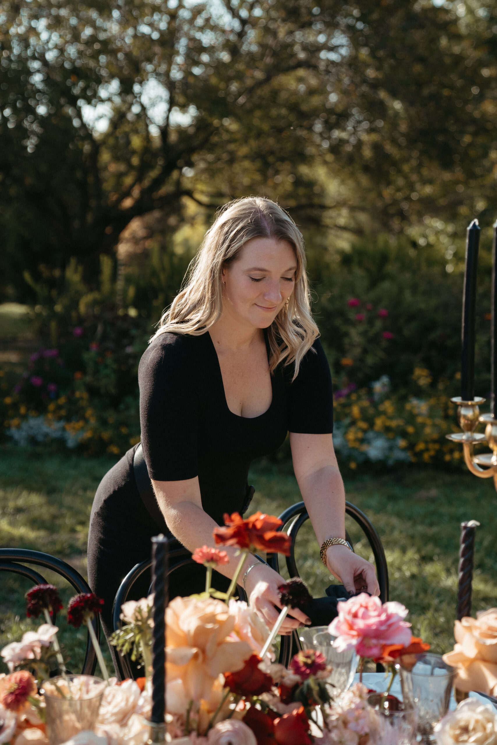 wedding planning secrets - wedding planner adding finishing touches to reception table