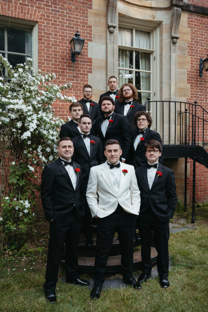 real-wedding-feature groom with his groomsmen standing on the stairs in the garden