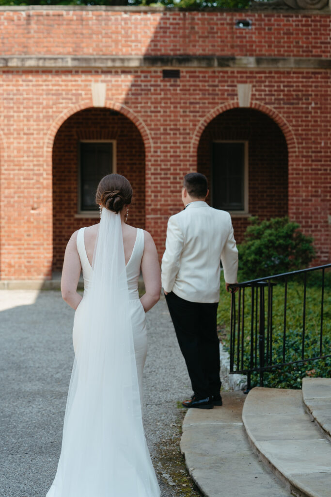 real-wedding-feature bride waiting for the groom to turn around before their first look- real wedding feature