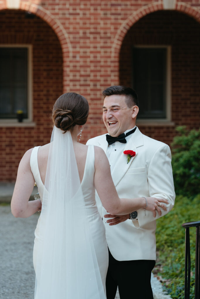 real-wedding-feature bride and groom laughing as the groom turned around for the first look before their vows