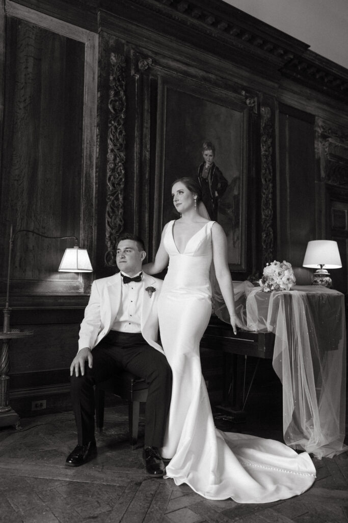 real-wedding-feature black and white photo of the bride and groom sitting by the piano