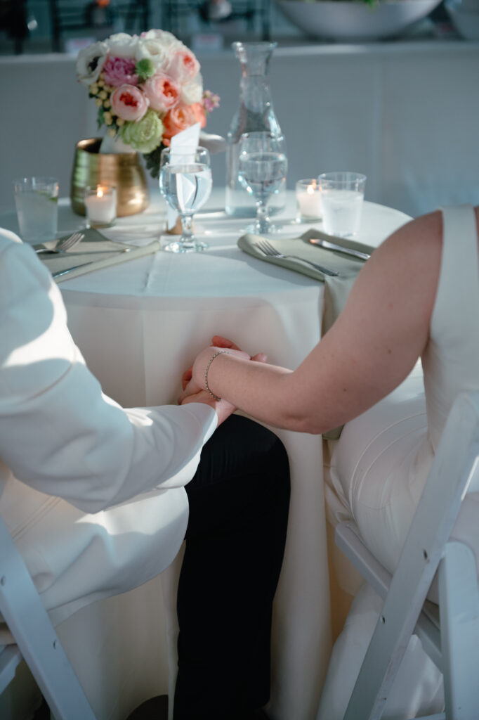real-wedding-feature bride and groom holding hands at their wedding reception