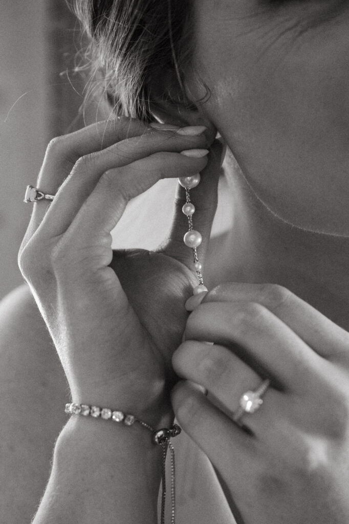 real-wedding-feature wedding details of the bride putting on her earrings at a real wedding feature