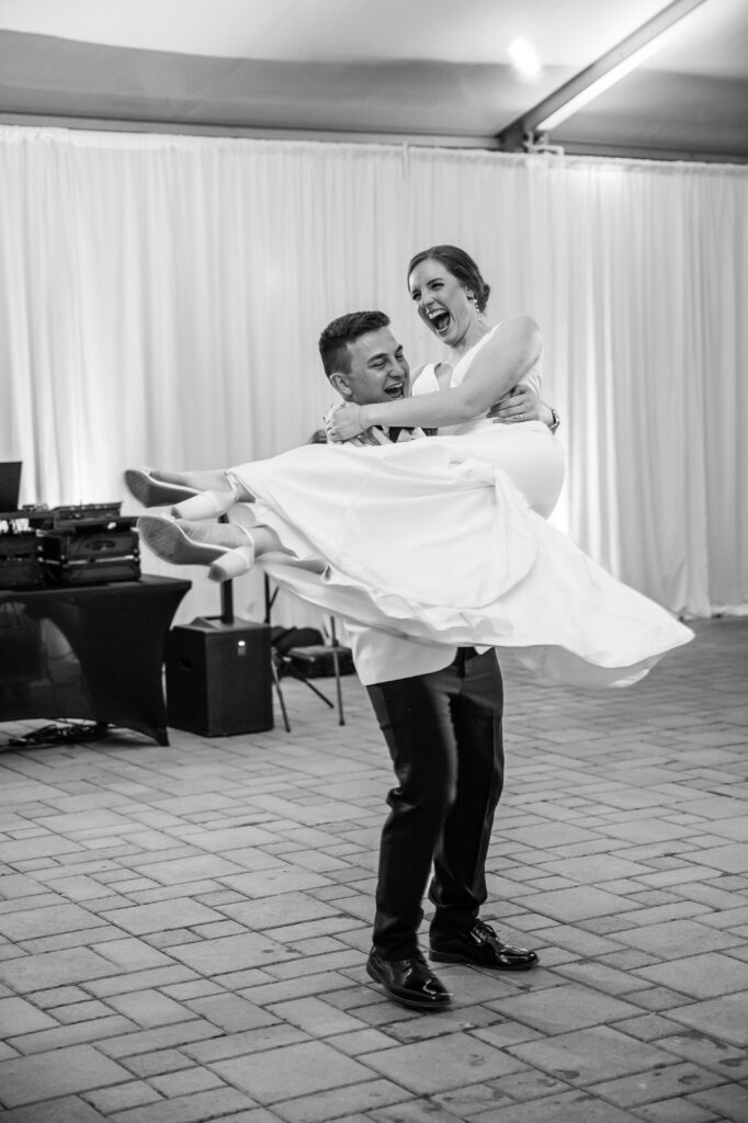 real-wedding-feature groom spinning his bride during their first dance at a real wedding feature