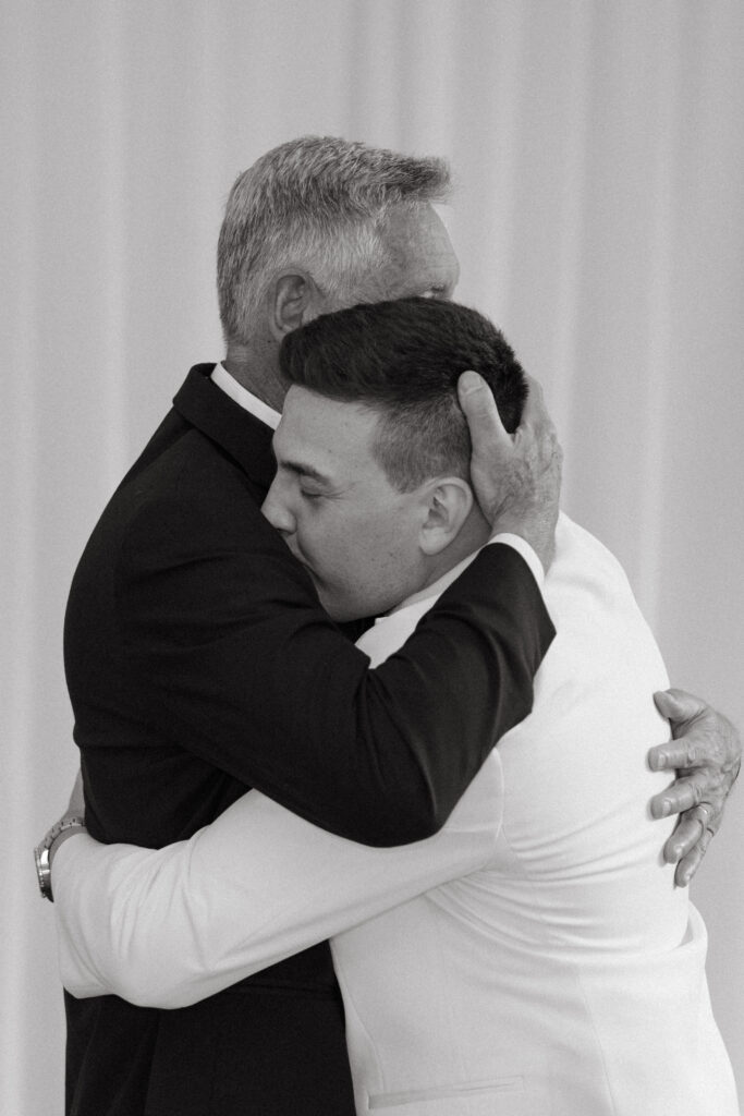 real-wedding-feature groom hugging the father of the bride