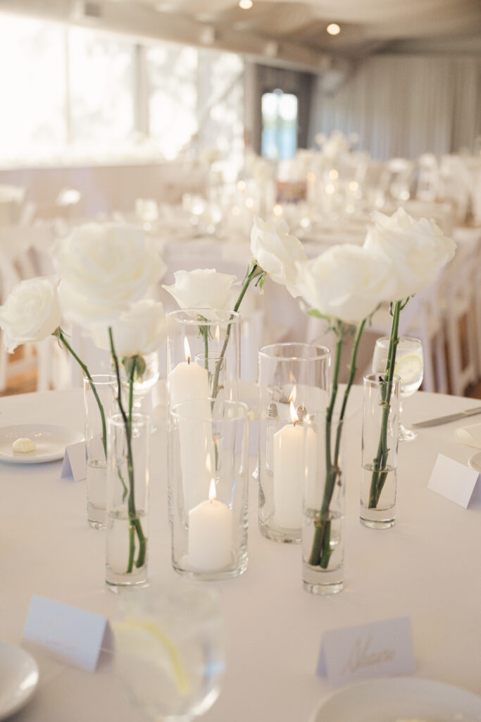 Elegant white roses and candlelight create a romantic, refined atmosphere at Pinecroft at Crosley Estate.