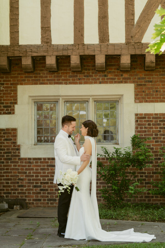 The couple shares a quiet, intimate moment outside Pinecroft at Crosley Estate, surrounded by historic charm.