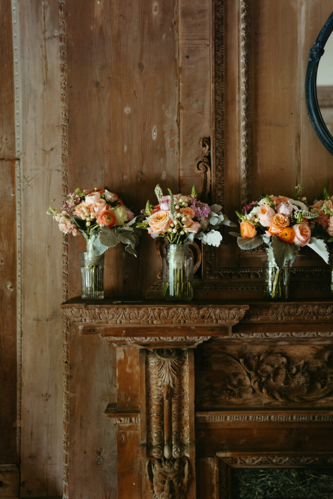 wedding-color-palette Classic wedding color palette with soft peaches, pinks, and greens beautifully arranged on vintage mantel.