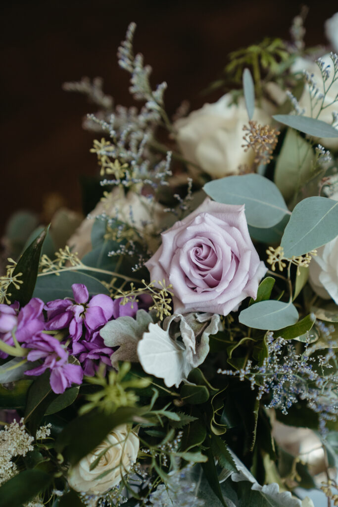 wedding-color-palette Elegant wedding color palette featuring soft lavender roses, creamy whites, lush greenery, and delicate floral accents.