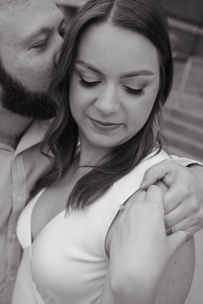 engagement-photo-tips Close-up of a couple sharing an intimate moment during their Cincinnati engagement session, highlighting the engagement ring and captured as part of creative engagement photo tips.