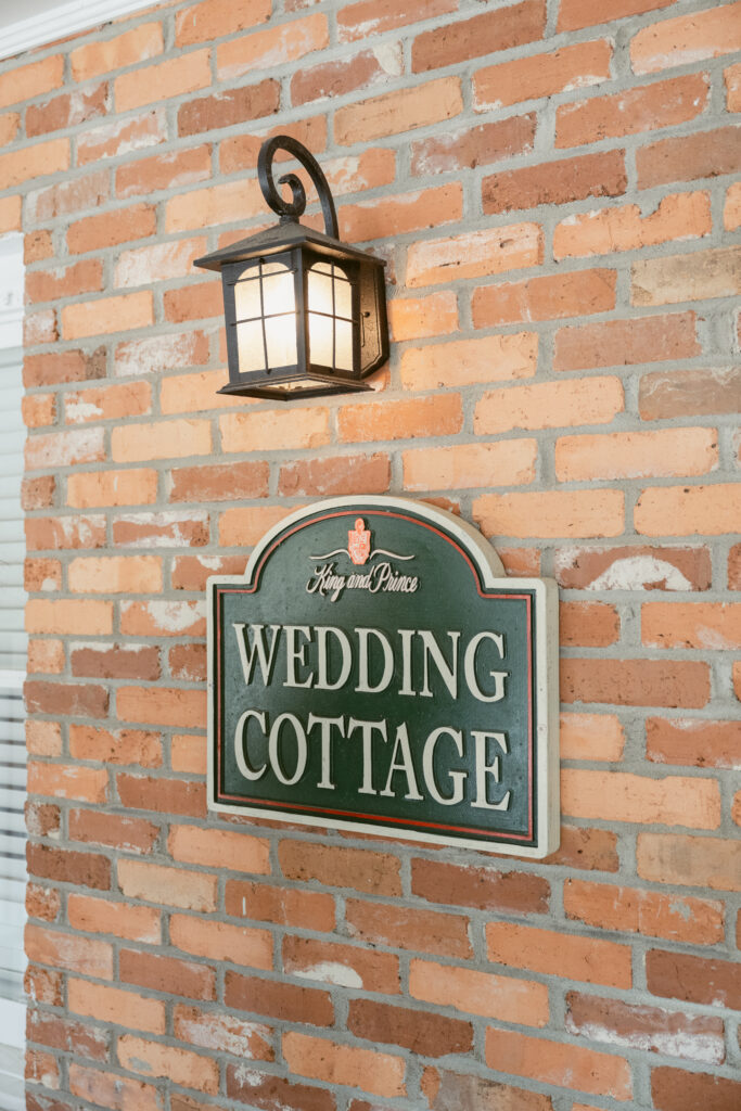 The exterior sign for the Wedding Cottage at The King and Prince Resort, a charming preparation space for a Georgia wedding.