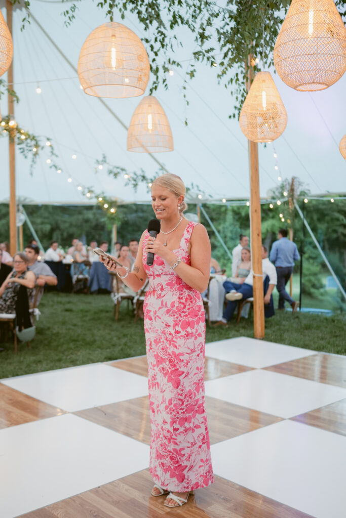 Maid of Honor standing on a checkered dance floor sharing her speech