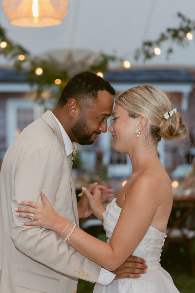 bride and groom looking at eachother lovingly as they share their first dance as hussband and wife