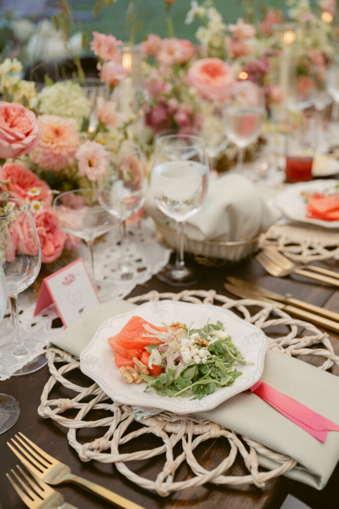Close-up of watermelon arugula salad served at a summer wedding reception, styled with elegant florals and place settings - Wedding at Meshewa House