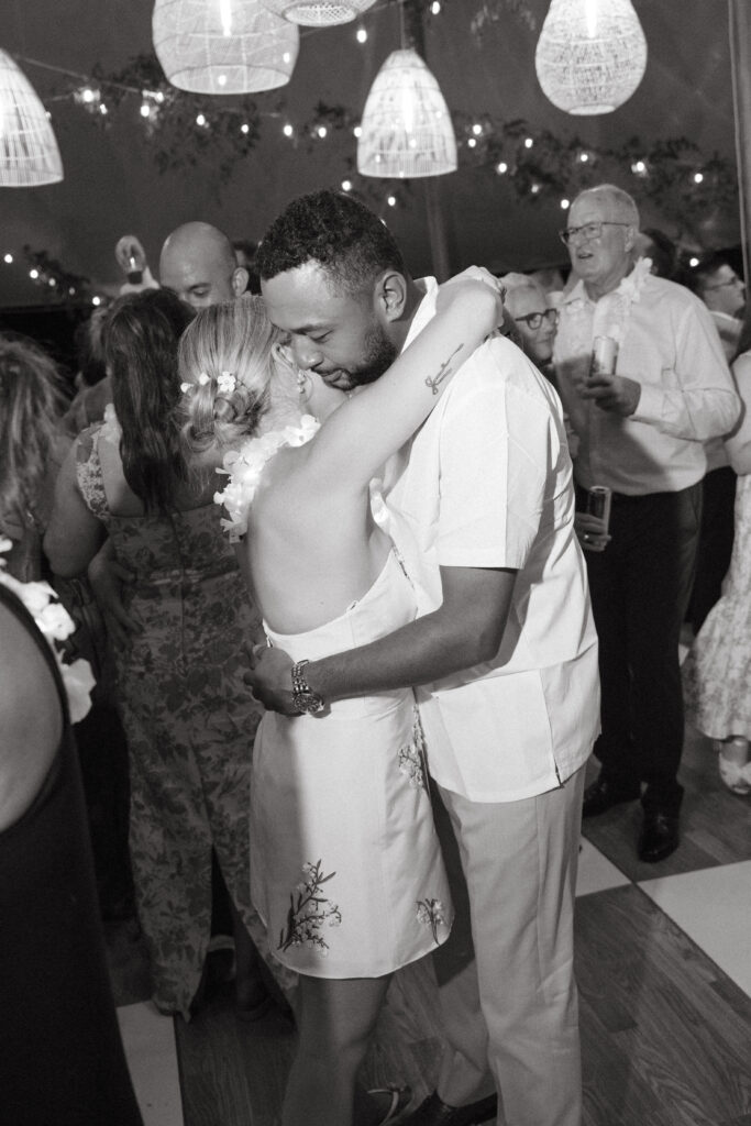 bride and groom dancing close in a black and white photo surroundded by their guests on the dance floor at a Wedding at Meshewa House