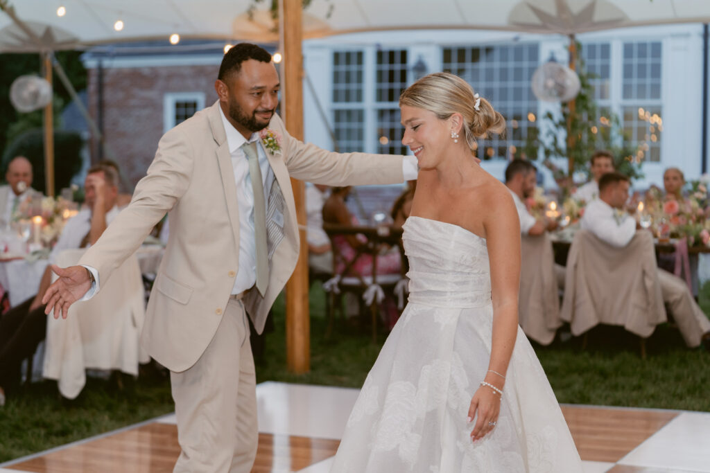 bride and groom laughing and having a good time during their first dance as husband and wife