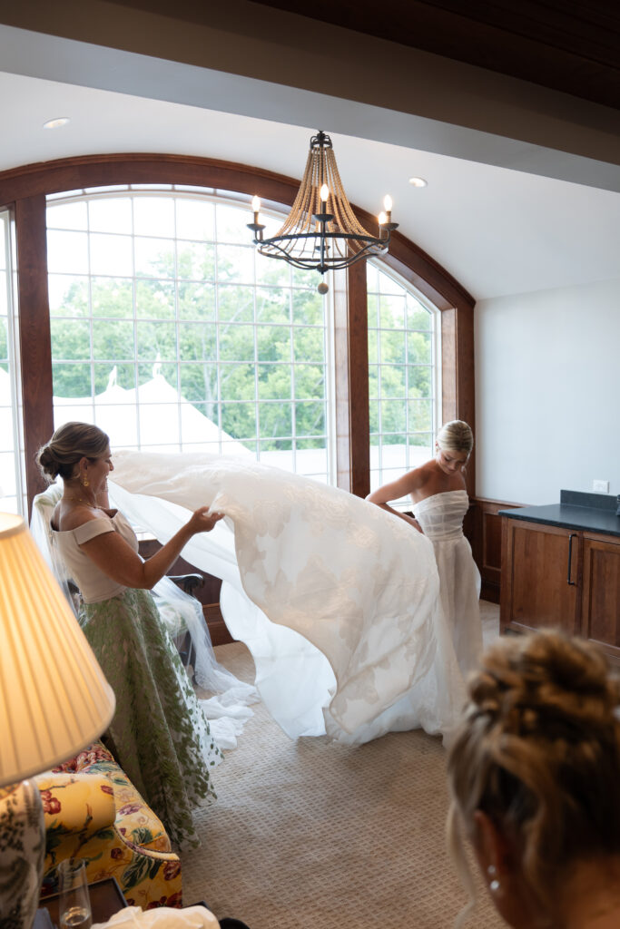 Bride getting ready as her mom helps with the gown, captured by wedding photographers in Cincinnati.
