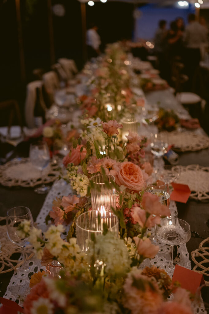 Romantic candlelit wedding reception table with lush pink florals and lace runner, Wedding at Meshewa House