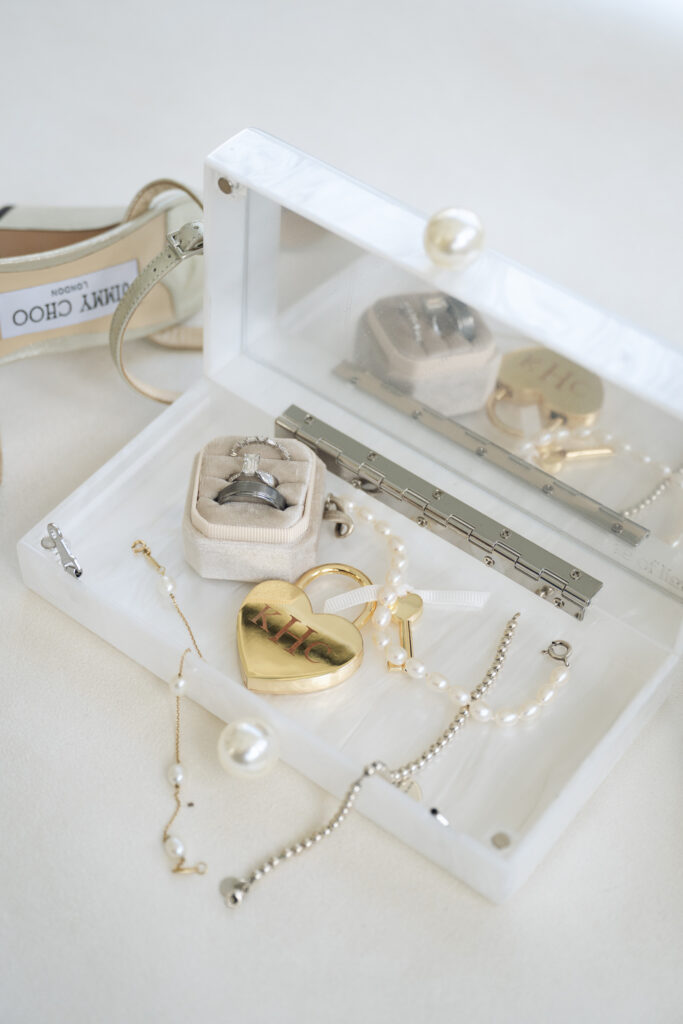 Detail photo by Cincinnati wedding photographer of bridal rings, pearls, and heirloom gold heart locket.