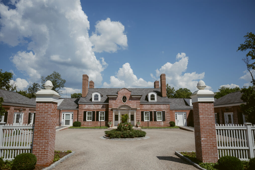 Elegant wedding venue with brick architecture and blue skies by Cincinnati wedding photographers.