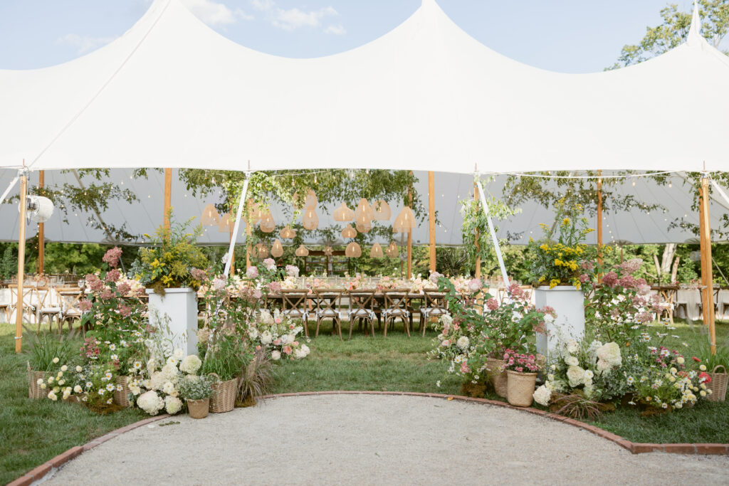 tented outdoor garden reception with lush florals