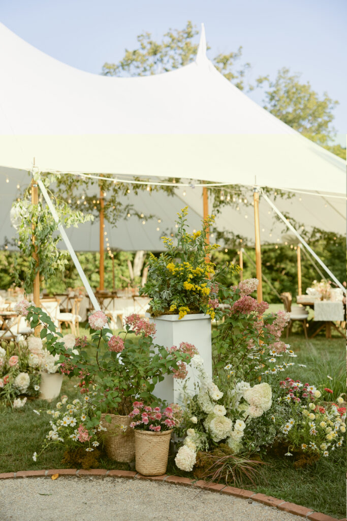 tented garden cocktail space with lush florals
