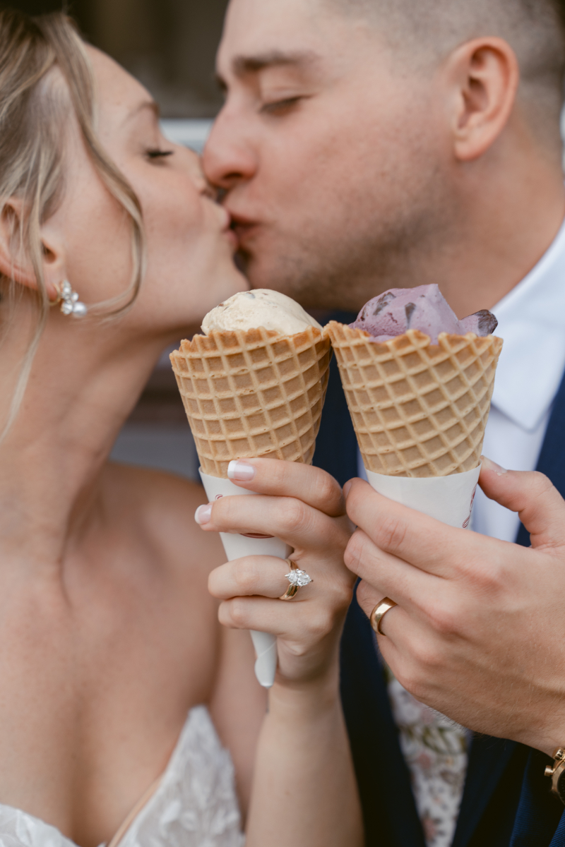 bride and grrom kissing with ice cream cones while designing guest experience