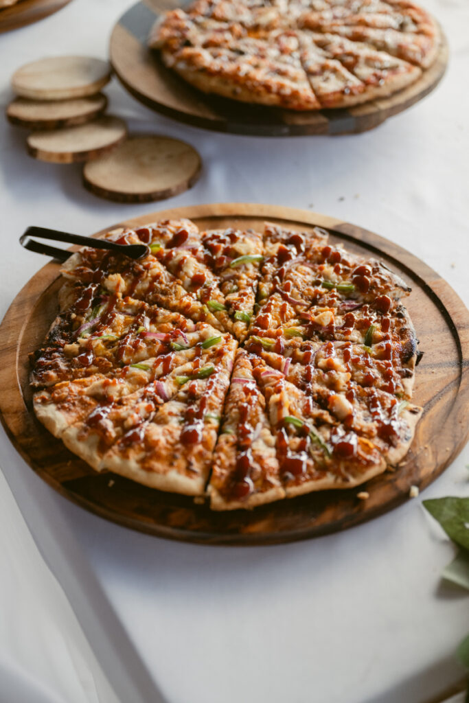Freshly baked pizzas on wooden boards, offering a fun and casual touch when designing guest experience.