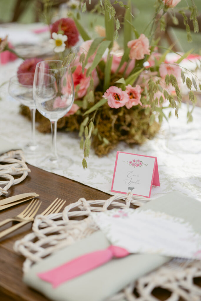 Elegant table setting with floral details and name card, a key part of designing guest experience.