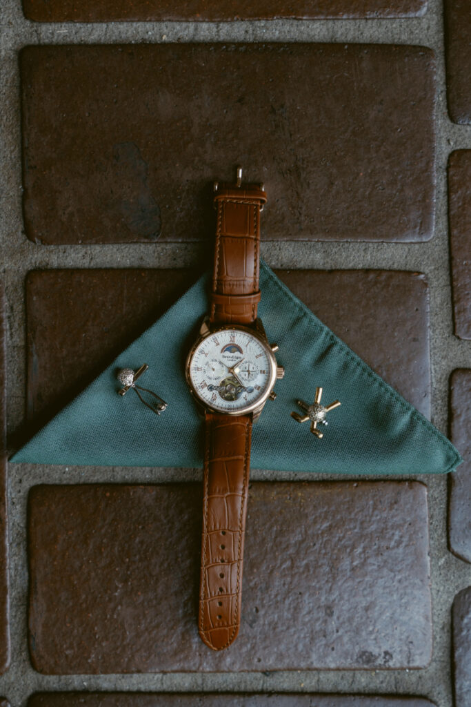 Groom’s watch, cufflinks, and green pocket square styled before a Downtown Cincinnati Wedding.