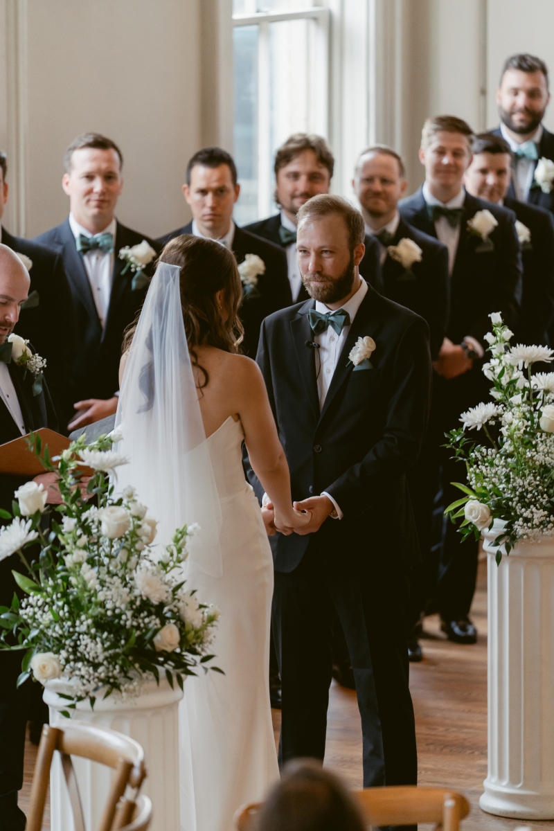 Bride and groom holding hands during their Downtown Cincinnati Wedding ceremony at The Alcove.