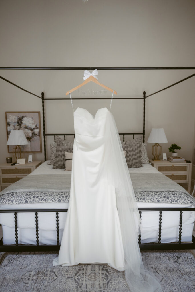 Full view of bride’s dress and veil hanging in a bedroom before a Downtown Cincinnati Wedding.