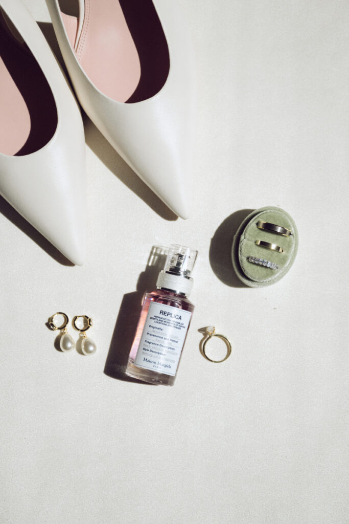Bridal shoes, rings, perfume, and jewelry flat lay before a Downtown Cincinnati Wedding.