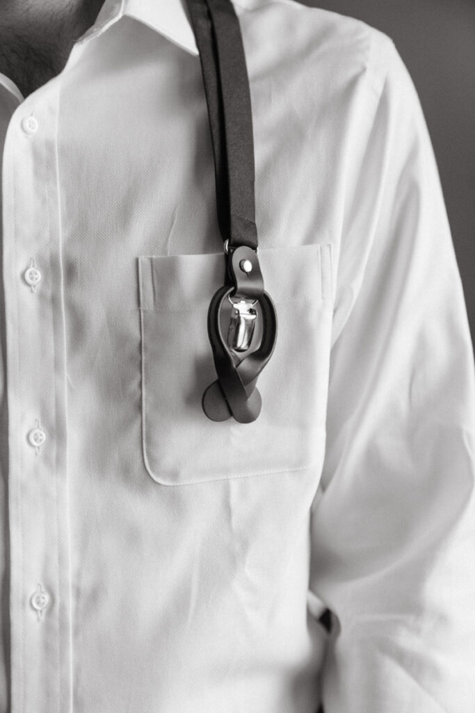 Groom wearing suspenders over a white shirt while getting ready for a Downtown Cincinnati Wedding.