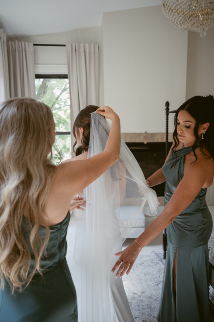 Bridesmaids help the bride with her veil before a Downtown Cincinnati Wedding ceremony.