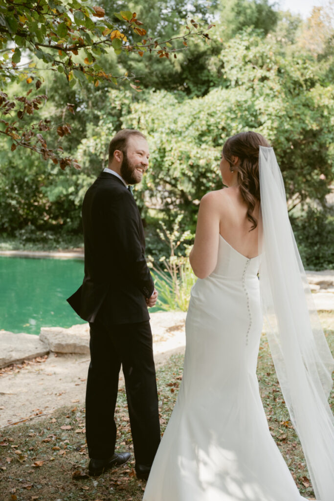 Bride and groom smiling at each other during their first look at a Downtown Cincinnati Wedding.