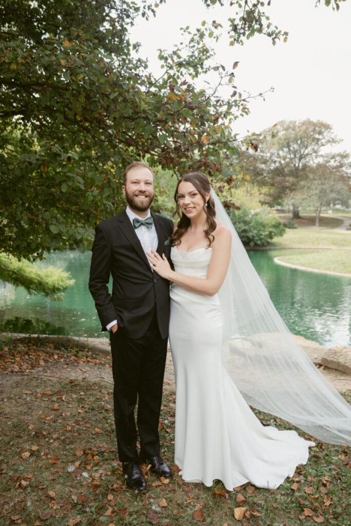 Bride and groom pose together by the pond during their Downtown Cincinnati Wedding at Eden Park.