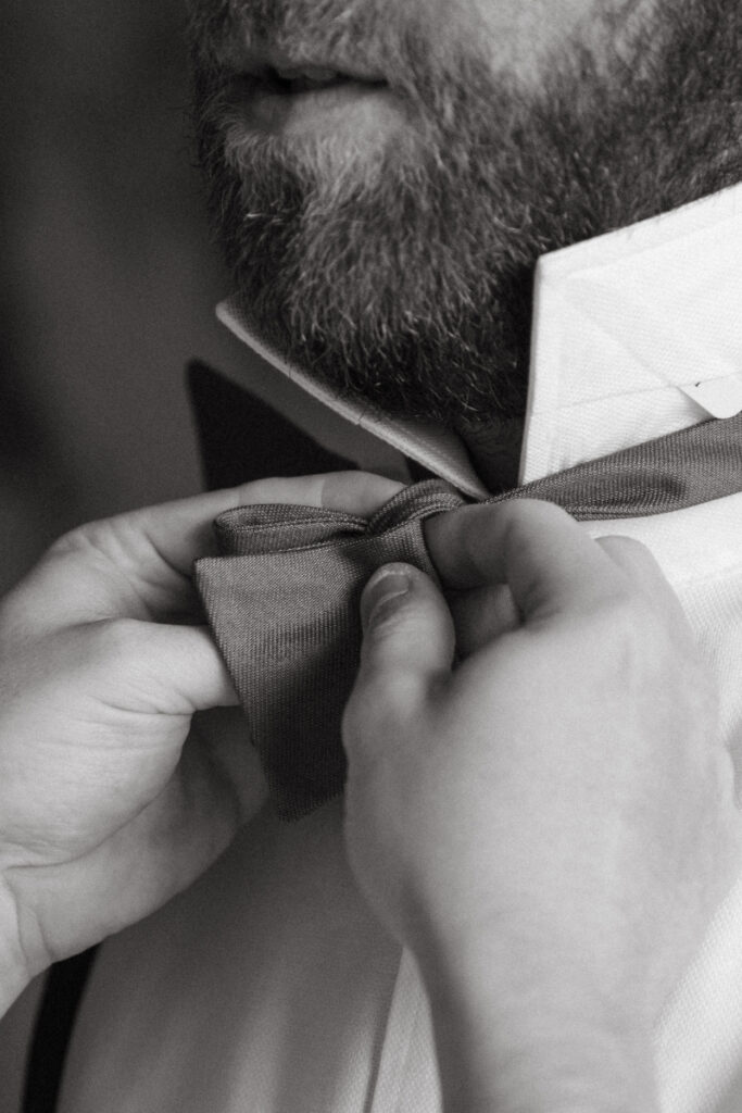 Close-up of groom’s bow tie being adjusted before a Downtown Cincinnati Wedding ceremony.